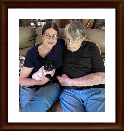 Christina and James with their new baby girl Emily - Black Pug Puppies | I think we are drawn to dogs because they are the uninhibited creatures we might be if we weren't certain we knew better.