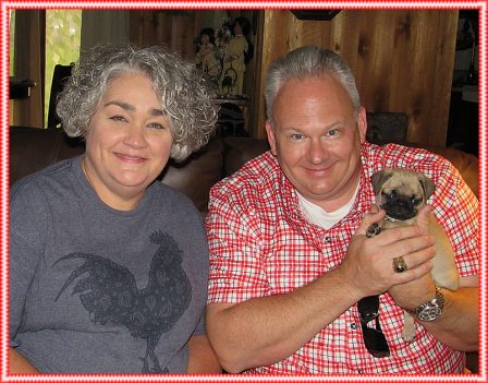 Puddin's little girl Glory/Marley with her new mom and dad - Apricot Pug Puppies | Petting, scratching, and cuddling a dog could be as soothing to the mind and heart as deep meditation and almost as good for the soul as prayer.