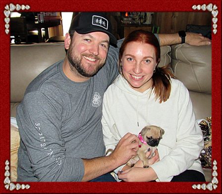 Siggy/Josie with her new mom and dad, Tara and Patrick - Fawn Pug Puppies | Even the tiniest dog is lionhearted, ready to do anything to defend home and family.
